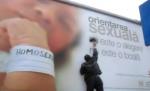 Protest anti-gay. Trei bărbaţi vopsesc peste un panou informativ