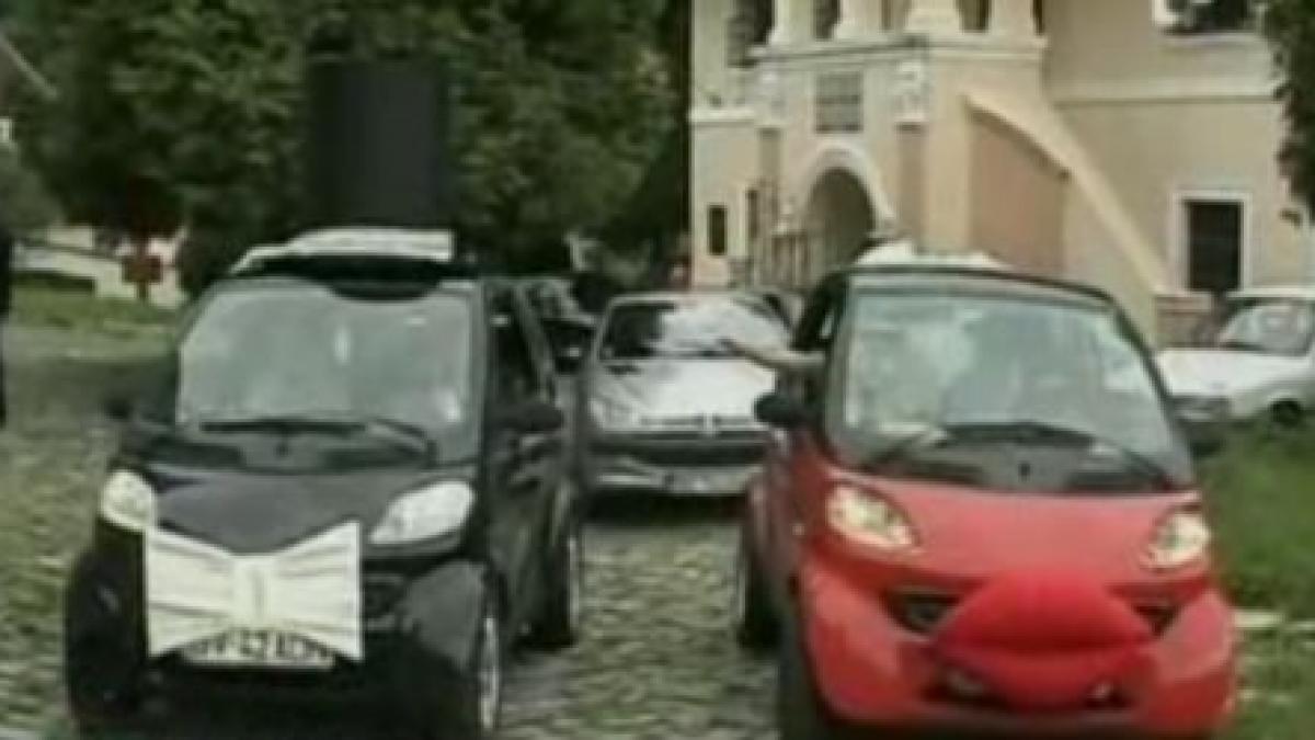 doi brasoveni si au decorat masinile in costume de mire si mireasa in ziua nuntii lor