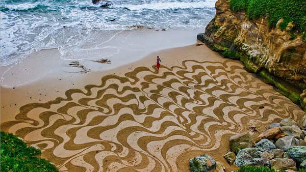 este uluitor ce face acest barbat cu o grebla pe plaja sunt adevarate opere de arta