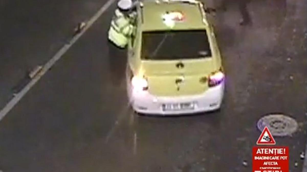 un politist a fost tarat 50 de metri de un taxi vezi imagini