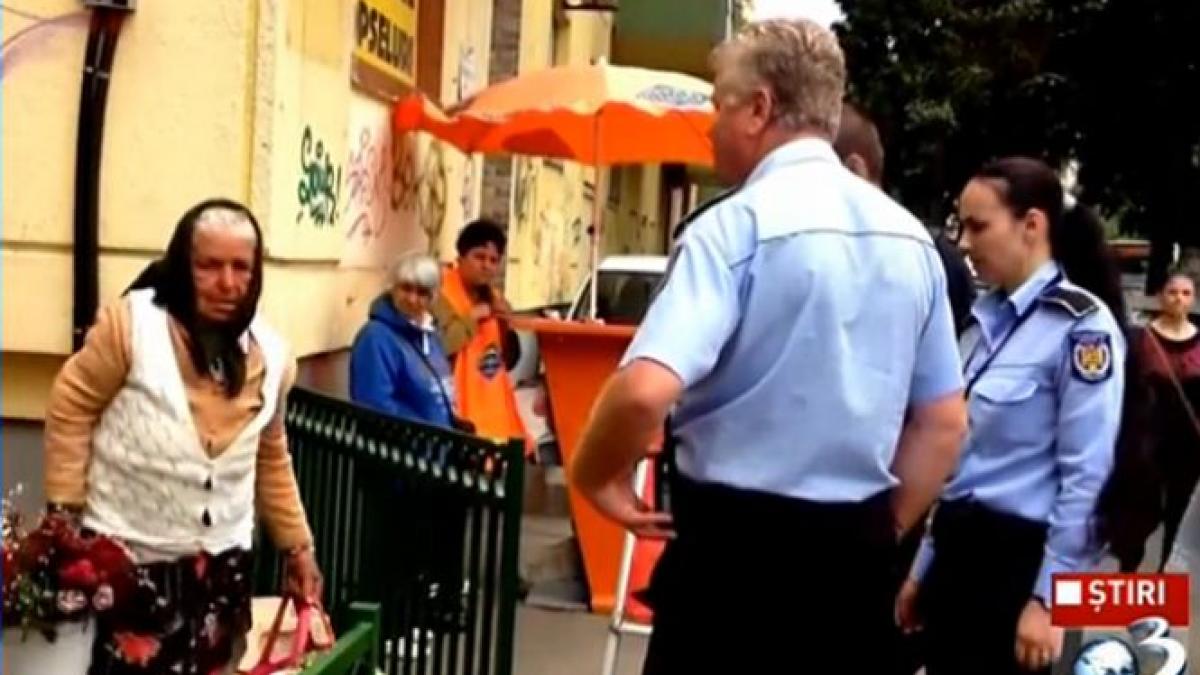 batrana amenintata de politisti pentru ca vindea flori