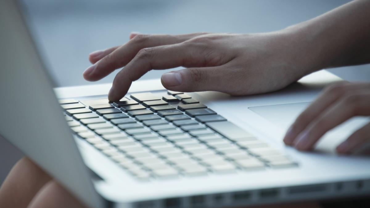 Tânără care foloseşte un laptop