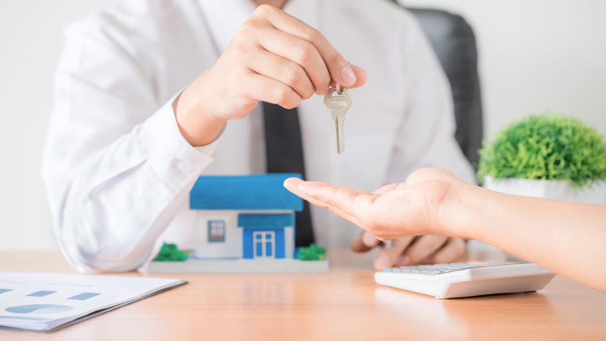 agent imobiliar oferă cheia apartamentului noului proprietar