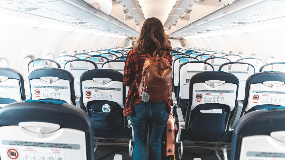 femeie care isi cauta locul in avion