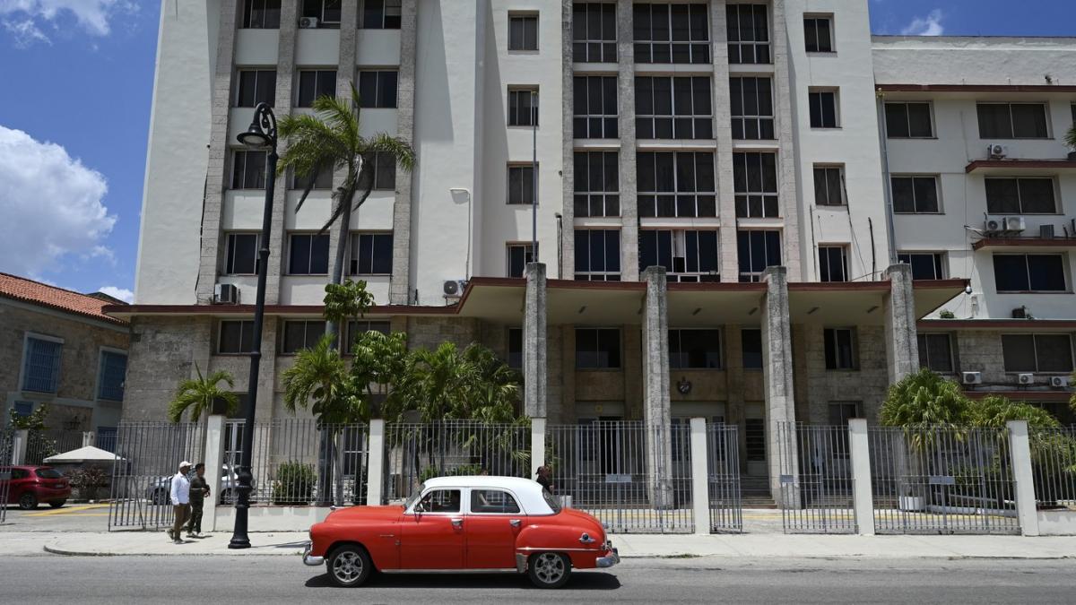 sediul companiei Gaesa, in havana, cuba, cu o masina rosie in fata