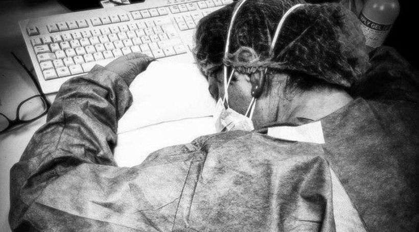 Coronavirus Italia. O asistentă epuizată de munca din spital, surprinsă dormind cu capul pe birou