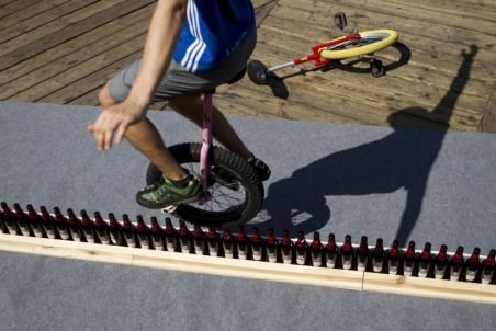  Nou record mondial: Un german a mers cu monociclul aproape nouă metri pe o linie din sticle de bere 