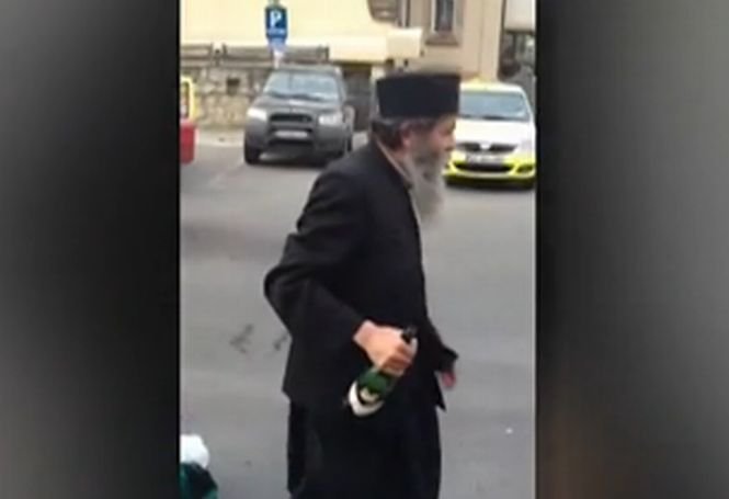 Un călugăr beat, filmat în timp ce arunca vin după taximetrişti