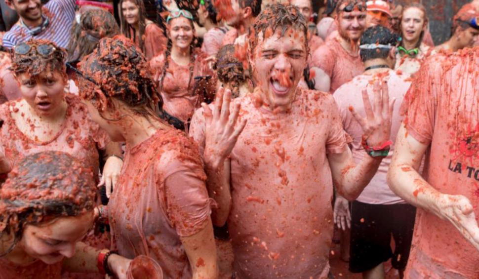 VIDEO Cel mai mare festival la care oamenii plătesc să se bată cu roșii: 22.000 de participanți au colorat străzile din Spania în roșu 920015