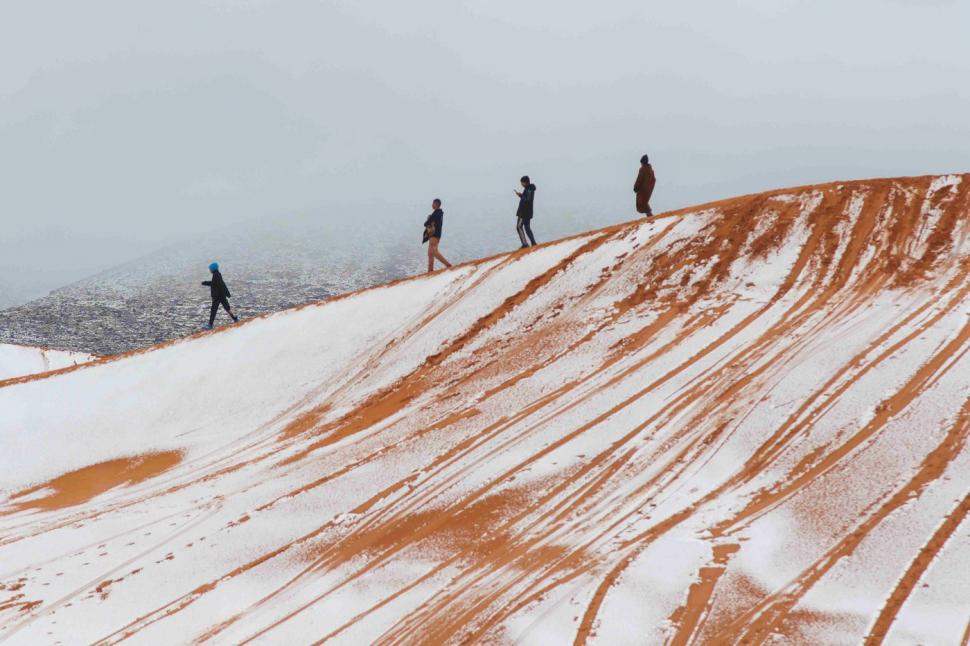 Peisaj SF în Sahara, unde a nins iar zăpada a acoperit dunele de nisip. Localnicii din apropiere s-au dus la derdeluș 1052935