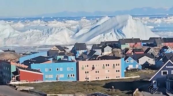 imagini spectaculoase cu un aisberg urias care s a rasturnat langa o insula din groenlanda